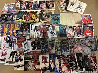 Wide view showing various NHL player hockey cards in a spread. Cards show different players, including a mix of color and monochrome photos, many featuring Calgary Flames players.