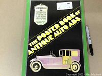 Cover of the book titled 'The Poster Book of Antique Auto Ads' featuring a yellow and purple antique car and green border on the cover