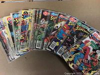 Photo showing 25 vintage DC Comics Presents comics fanned out, each in plastic protection, with various colorful Superman cover arts.
