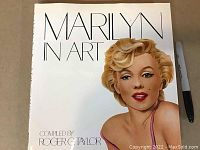 Front cover of the book showing the title 'Marilyn in Art' with a large colorful illustration of Marilyn Monroe's face and upper torso.