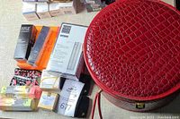 Top-down view showing cosmetic case and several boxed cosmetic products from luxury brands on a table