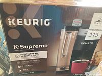 Box showing front image of Keurig K-Supreme coffee maker with branding and features highlighted