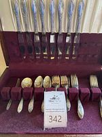 Full open case showing knives in lid and forks and spoons in base rack