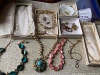 Overall view of top row boxes and bottom row assorted necklaces and chain