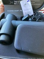 Massager, DC adapter and carrying case shown in black molded case.