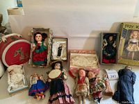 Overview of assorted dolls, Minnie Mouse case, boxes and clothing