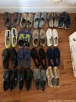 Photo showing 20 pairs of shoes laid out on the floor, primarily casual and athletic shoes in sizes 7.5 and 8.