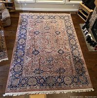 Full view of rug laid flat on hardwood floor