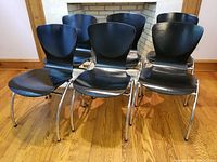 Set of 6 Kimball Office midmod black stacking bent plywood chairs with chrome legs shown from front.