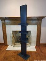 Front view of the blue retail display tower showing its height, base, and shelves.