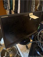 EMachines black computer monitor screen and bezel with emachines logo visible on front left.