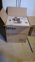 Original cardboard box labeled 'Ninja Hot & Cold Brewed System Model CP307 32'.
