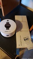 Apple 85W MagSafe 2 Power Adapter box next to Motorola Moto 360 box, showing brand and product names
