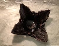 Top-down view showing the star-shaped design and swirl pattern with gold highlights.