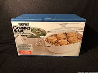 Box front showing French White Corningware 5-piece serving set with casserole dish, lid, and cradle.
