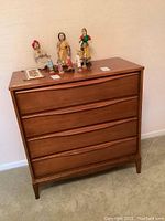 Front view showing four drawers with integrated curved handles