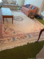 Full-room shot showing rug under coffee table between sofas