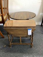 Darker round wooden drop leaf side table