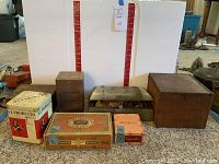 Overview of 7 assorted vintage cigar and storage boxes of different sizes and materials.