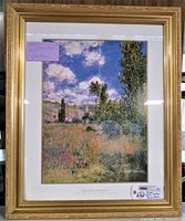 Framed print showing the full artwork and frame with gold colored ornate border and white matting beneath glass.