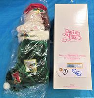 Photo of boxed Holly doll in original clear plastic wrapping with original box showing Precious Moments logo and collection name.