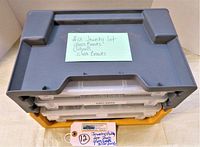 Closed view of 4 stacked storage drawers with a note describing lot contents: glass beads, pearls, silver bends.