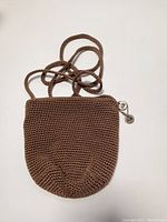 Full view of the brown crochet woven handbag showing overall condition and shape
