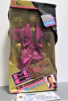 Front view of original boxed MC Hammer doll showing magenta suit, gold sunglasses accessory, and cassette tape inside box with visible wear on box edges.