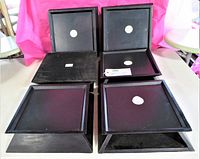 Top and angled view of six black wood square display stands showing their shape and size.