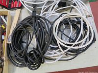 Photo showing coiled black and white cable wires mixed together, giving a view of length and type of wires included