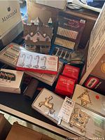 Overview photo of Christmas village house accessories and boxes on a table