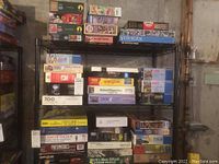 Full view of shelving unit with assorted jigsaw puzzle boxes stacked showing various brands and piece counts.