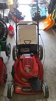 Front view of red Toro Recycler lawn mower showing engine cover and pull start cable.