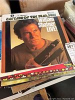 Top record with cover featuring William Shatner holding a phaser titled 'Captain of the Starship William Shatner Live!'.
