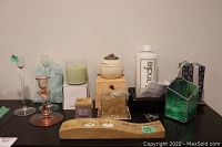 Photo showing the assortment of candles, glass holders, ceramic holders, and bag of decorative stones arranged on a surface.