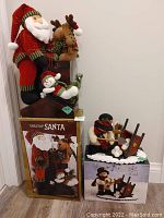 Photo of Tabletop Santa figure sitting with reindeer and snowman, box included