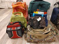 View of all included travel bags and accessories arranged on floor showing variety of colors, sizes, and styles.