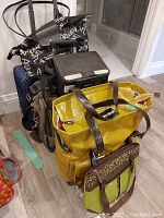 Photo of all bags and luggage stacked near a white wall