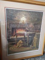 Full view of the framed print showing man and dog by fireplace.