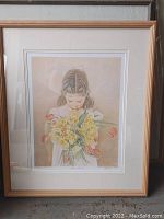 Full view of the framed print depicting a young girl holding flowers.