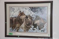 Framed and matted print showing three wolves in a snow-covered winter forest titled '3 Wolves In The Winter'.