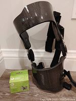 Townsend therapeutic knee brace in carbon fiber style finish showing side and straps