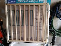 Front view of wood slat security gate with original box behind it