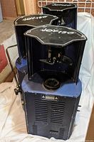 Three American DJ Joy 150 DJ lighting units, blue color, shown from various angles revealing top labels and casing condition.