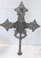 Front view of the handmade Ethiopian Coptic cross showing detailed lattice pattern and handle.