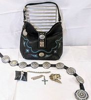 Front view of the purse showing turquoise and concho detail, belt laid flat with rhinestone conchos, silver bracelet, watch, turquoise cross necklace and horse belt buckle.