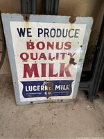 Front view of the rectangular sign showing full text, logo, and overall wear.