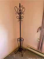 Full-height coat rack in corner showing overall structure and finish