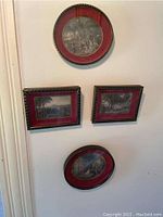 Four framed drawings displayed on wall showing framing and scale
