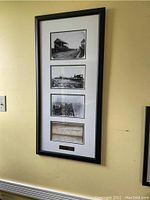 Full view of the framed commemorative piece hanging on a wall showing the three black and white photos and the handwritten constitution excerpt.
